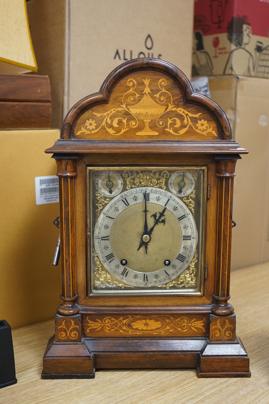 A rosewood mantel clock with French silk suspension movement, together with an Edwardian marquetry bracket clock signed to the dial S.Smith and son, Strand, London with a two train German movement striking on two coiled